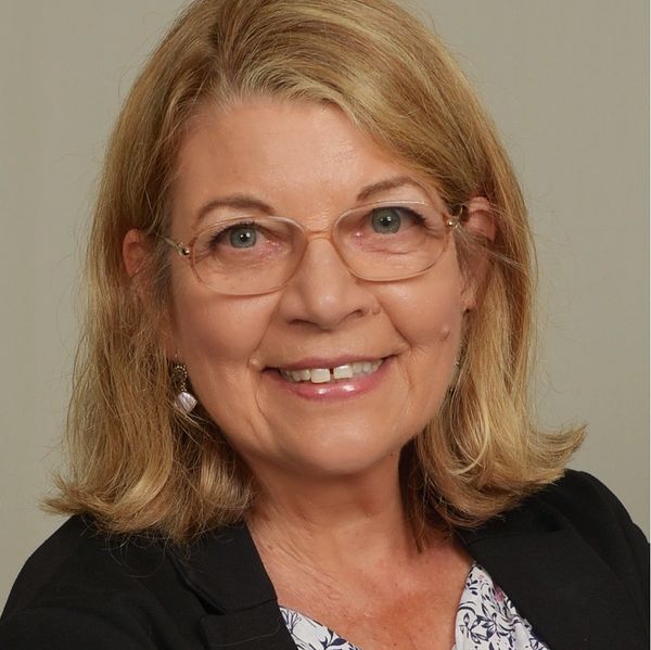 A smiling woman wearing glasses