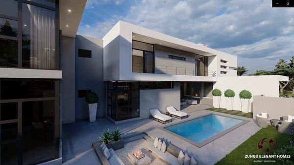 Modern two-story home with pool and outdoor lounge area under a partly cloudy sky.