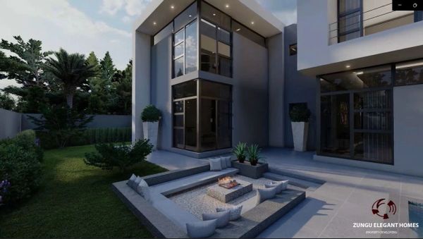 Modern home with sunken seating and fire pit in a landscaped garden.