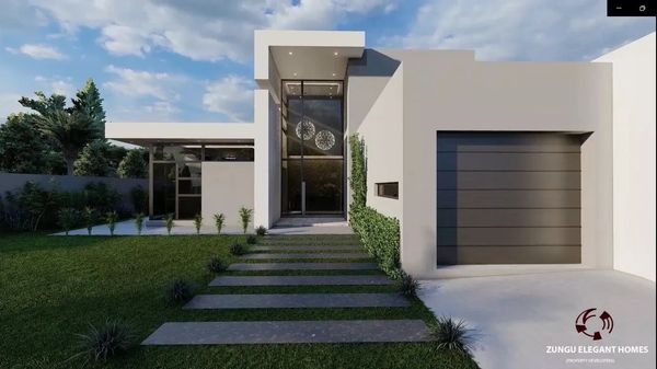 Modern white home with large glass entrance and sleek driveway.