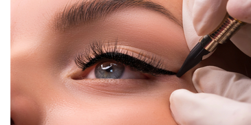 Performing a permanent eyeliner service for woman.