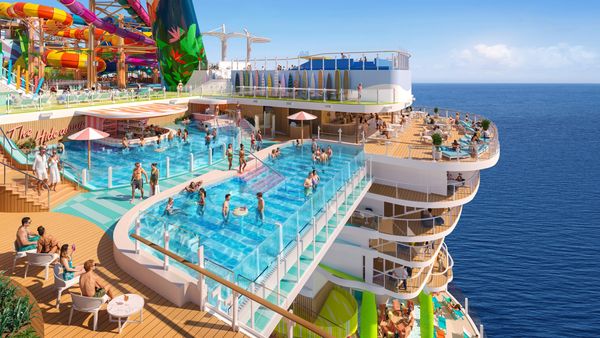 Luxury cruise ship pool deck with waterslides and ocean views.