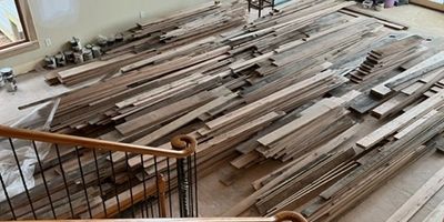 Wooden floorboards laid out for installation.