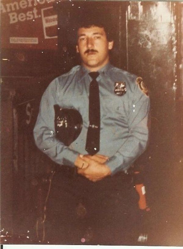 Vintage photo of a police officer in uniform.