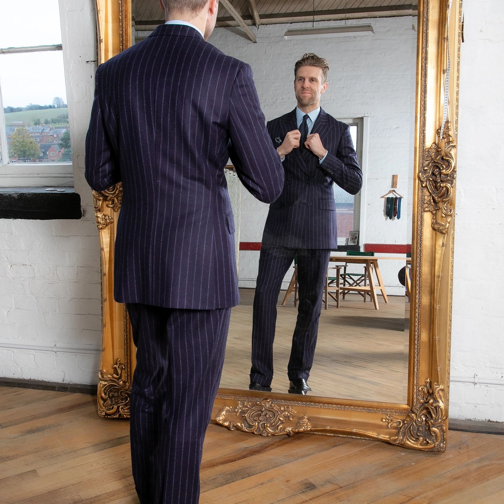 Nicholas checking his tie in the mirror