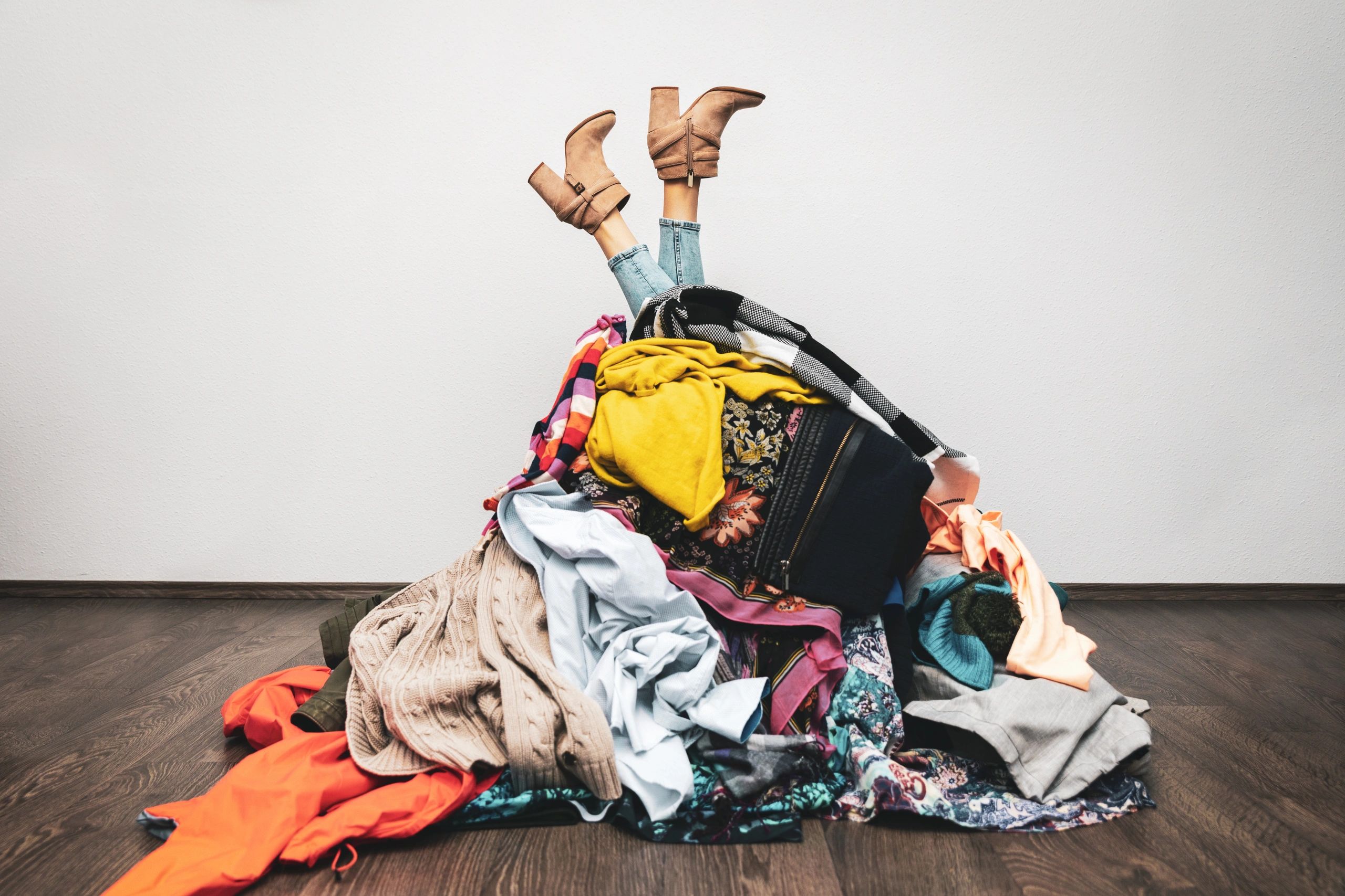 girl in boots covered in dirty laundry