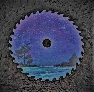 Circular saw blade painted with a serene night landscape scene.