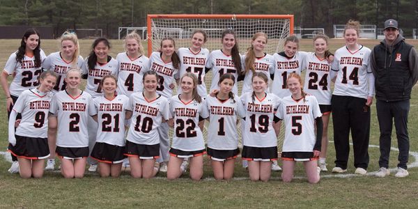 Bethlehem girls' lacrosse team posing in front of goal.