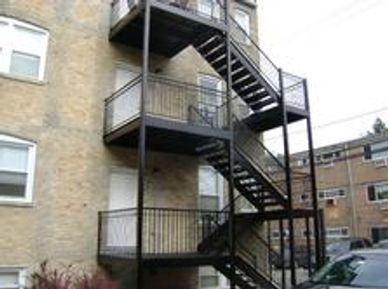 Wrought iron staircases scraped, primed & painted using a Rust-inhibitor paint.