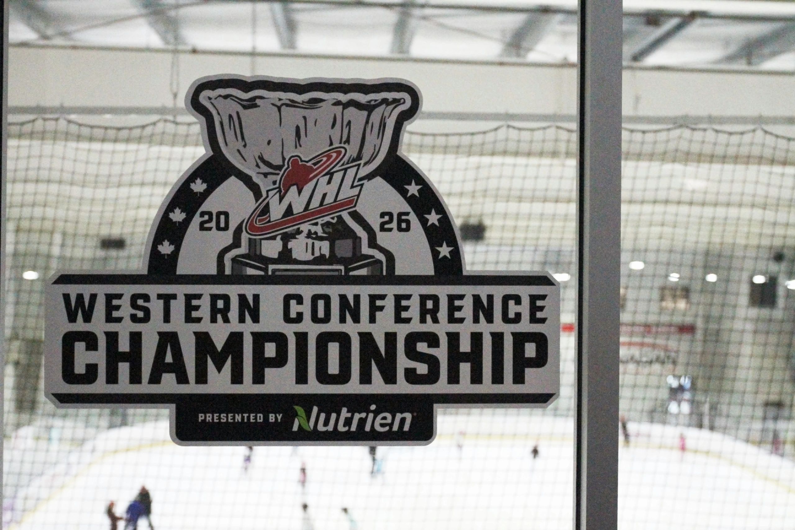 WHL Western Conference Championship sign on ice rink glass.