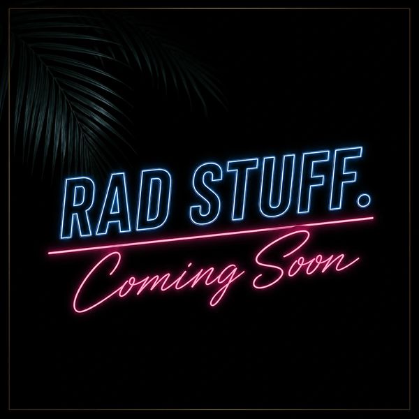 Neon sign reads 'RAD STUFF. Coming Soon' on a dark background with palm leaves.