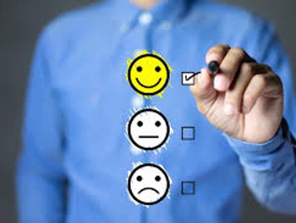Person selecting a happy face checkbox with a marker.