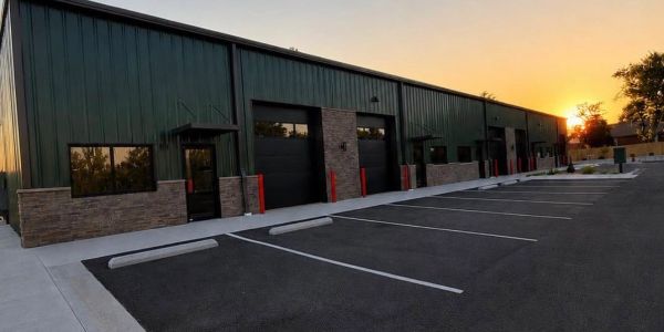 Industrial building at sunset with empty parking lot.
