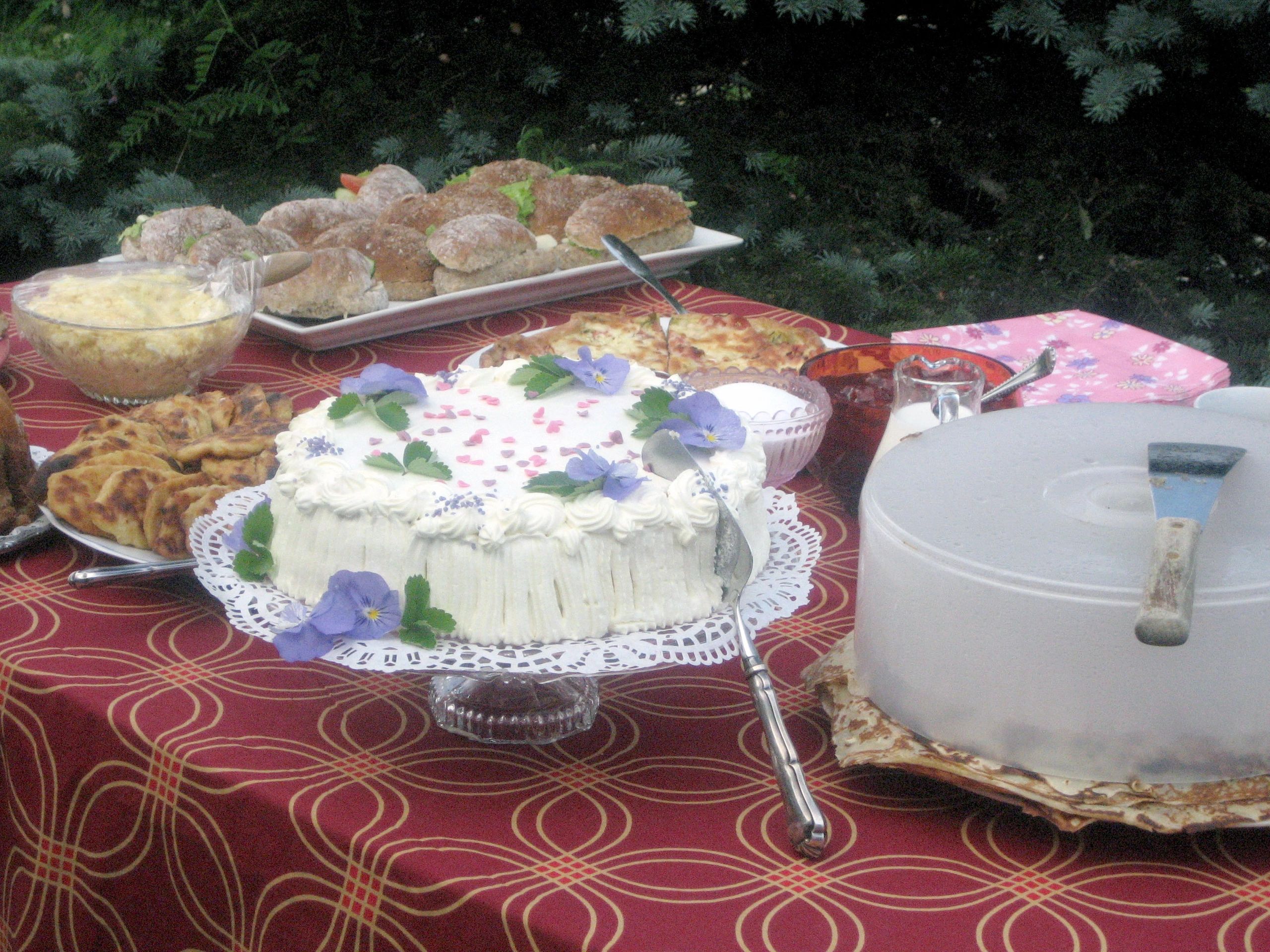 Finnish garden party, complete with cakes and pastries on a table.
