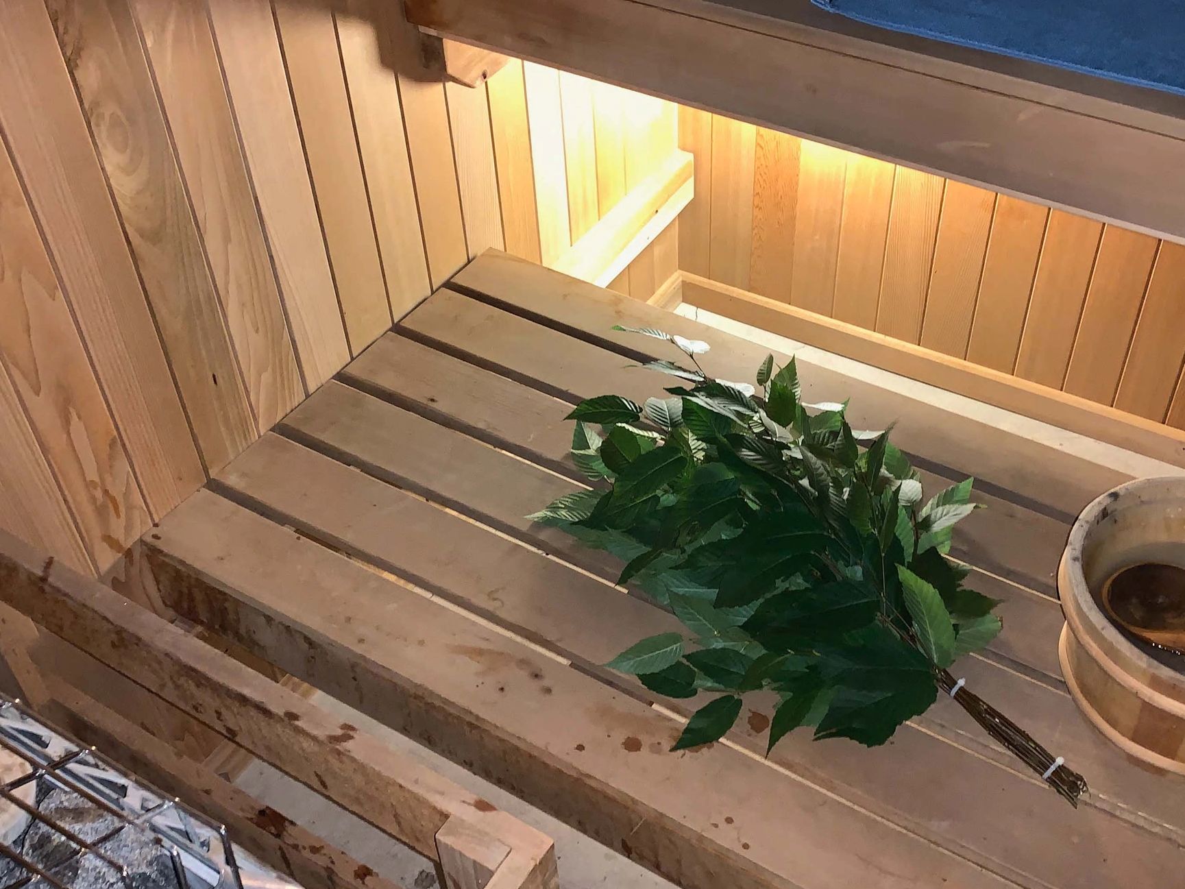 A sauna whisk sitting on a sauna bench