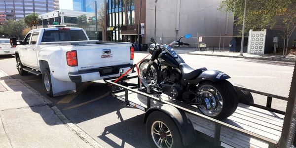 pickup towing a motorcycle