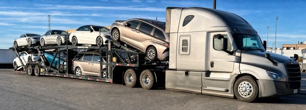 Car carrier truck loaded with multiple vehicles.