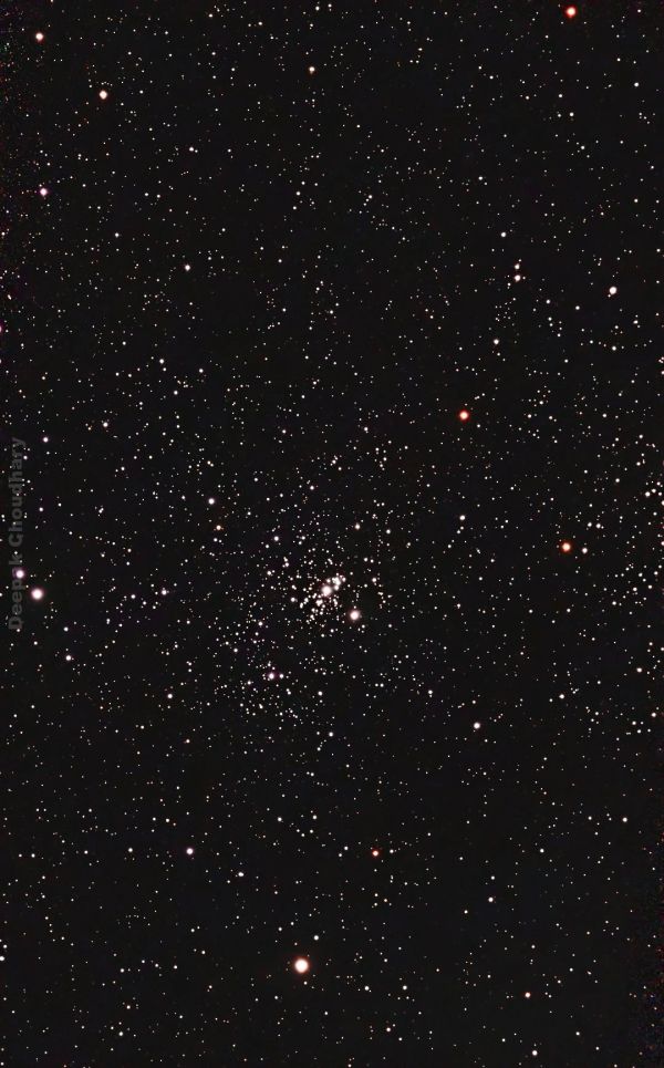 Dense star field with a bright star cluster at the center.