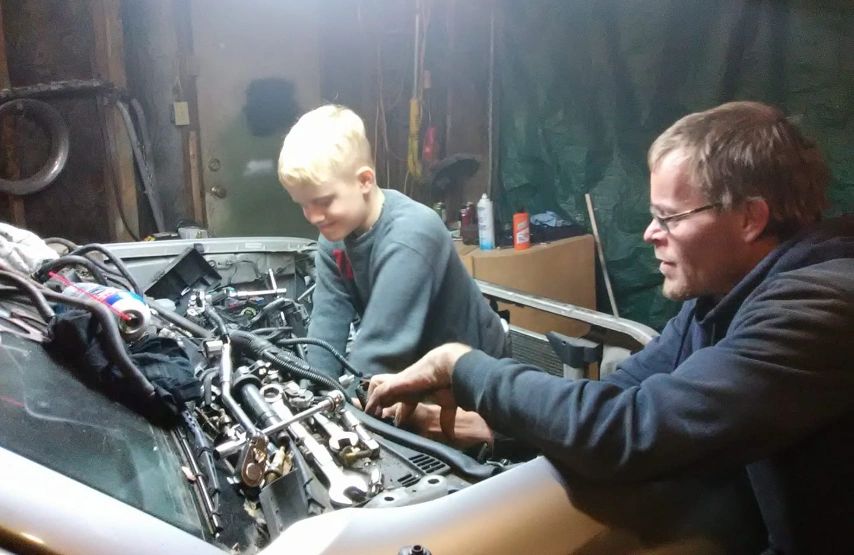 Greg and Josh working on a vehicle on-site