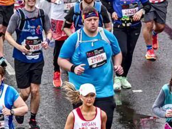 A diverse group of marathon runners participating in a race on a rainy day.