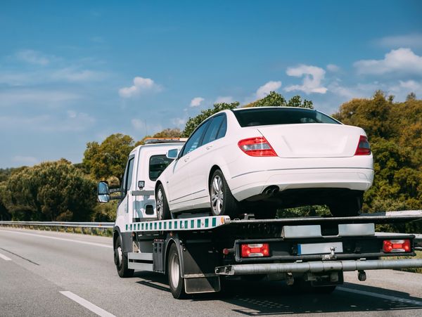 A truck transporting a car