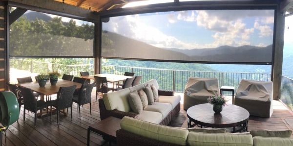 Cozy outdoor seating area with mountain views under a covered patio.