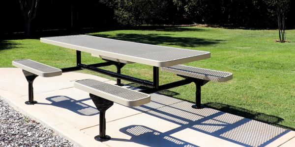 Metal outdoor picnic table with benches in a sunny park.