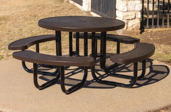 Metal outdoor picnic table with attached curved benches on a concrete surface.