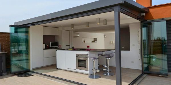 Modern open kitchen with glass doors and a breakfast island.