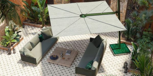 Modern outdoor seating area with two sofas and a large umbrella.
