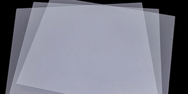 Three translucent plastic sheets overlapping on a black background.