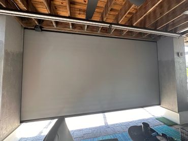 A closed, modern garage door in a wooden-beamed garage.