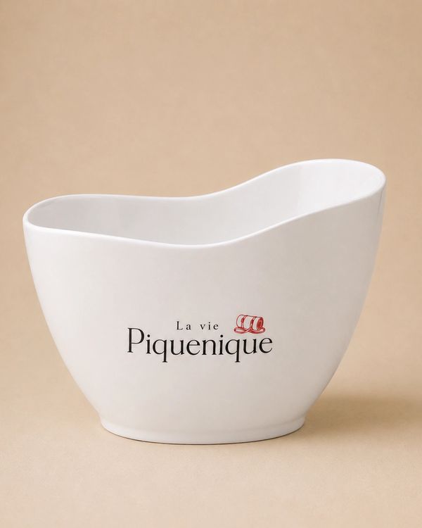 White ceramic bowl with French text and a small red design.