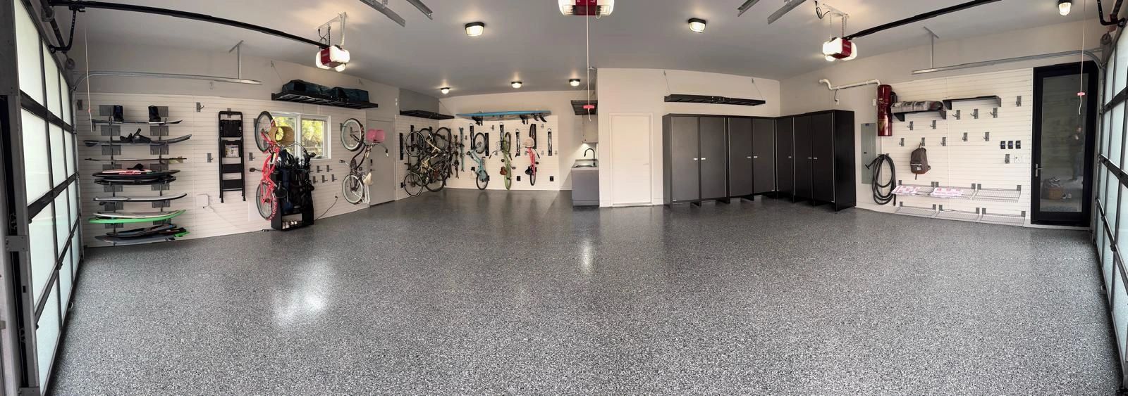 Vernon Custom Garage Signature Garage with cabinets, polyaspartic flooring, bike racks, slat walls