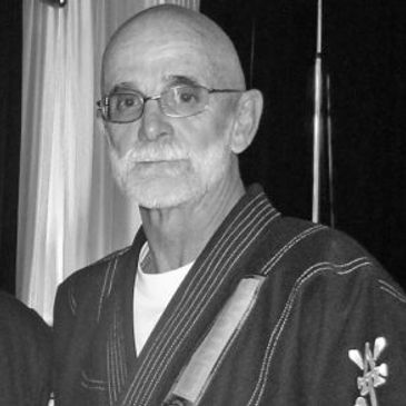Elderly man in martial arts attire.