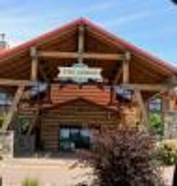 Entrance of a rustic log cabin lodge.