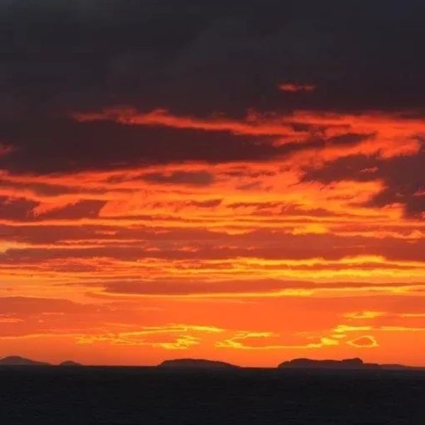 The Shiant Islands with a bright orange sunset