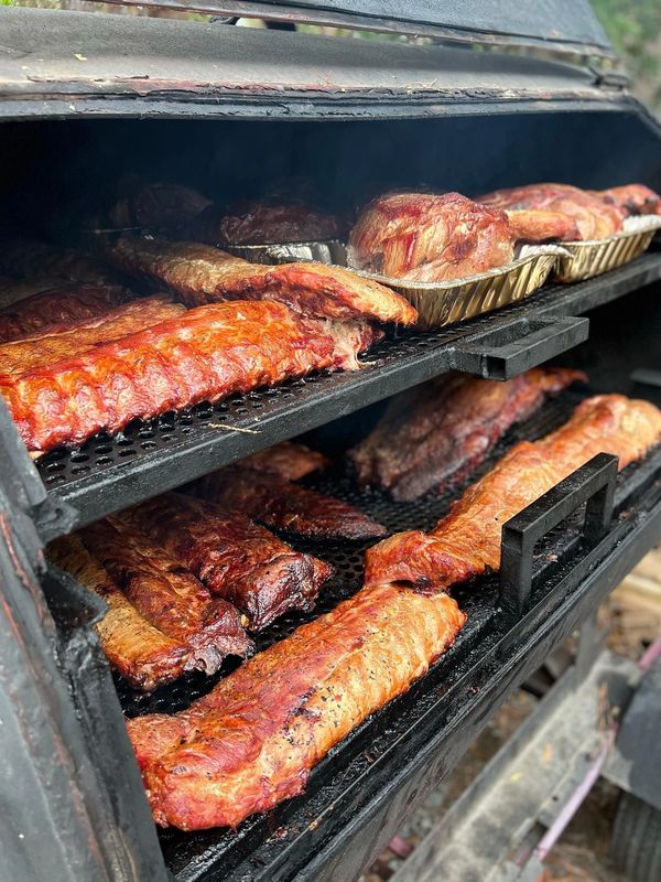 Meats grilling in a smoker