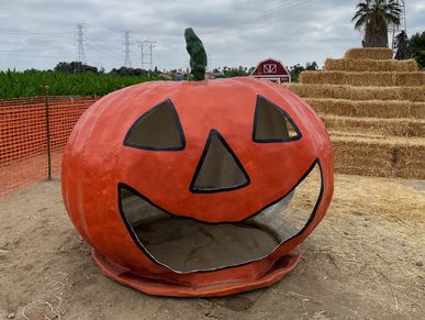 Large pumpkin-shaped structure with a jack-o'-lantern face.