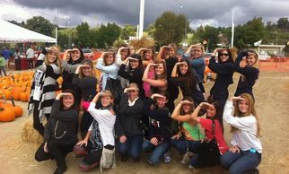 girls having fun at the pumpkin patch at forneris farms