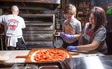 Chef cooking pizza with family. Commercial photo shoot in Snohomish, WA