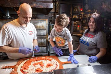 Chef building a pizza with family. Commercial photo shoot in Snohomish, WA