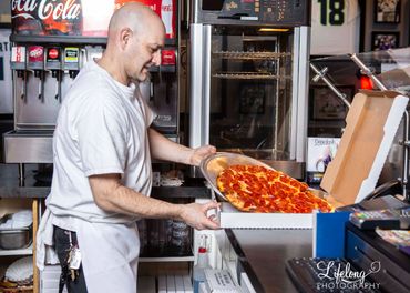 Boxing up the pizza in a branding, on location photo shoot.