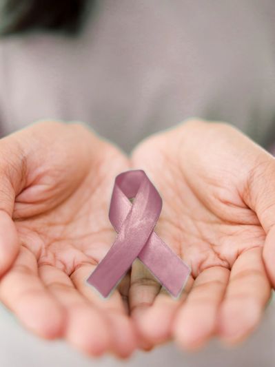 Image of two hands holding a burgundy ribbon, which signifies the brain aneurysm color ribbon.