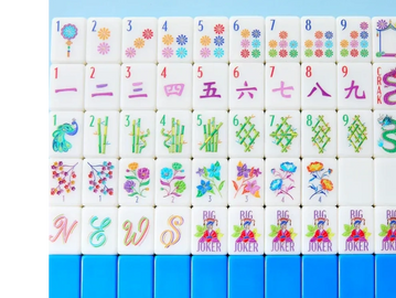 Colorful Mahjong tiles with floral designs and jokers.