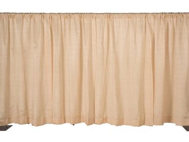 Beige pleated curtain with a gathered top.