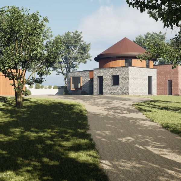 Modern stone and wood house with a round tower and driveway.