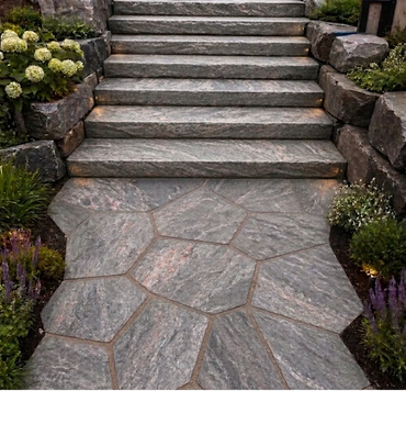 Stone steps and a flagstone pathway surrounded by greenery and flowers.