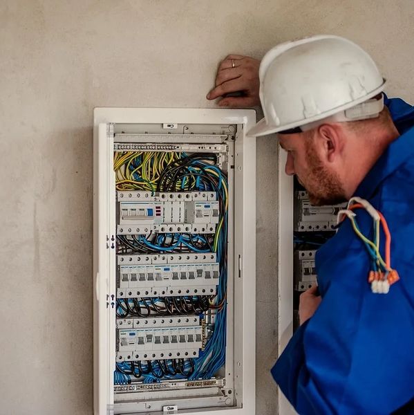 Electrician installing circuit breakers