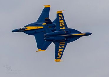 Two US Navy Blue Angels jets flying in close formation.